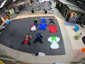 7 wing suits and 2 people on display 