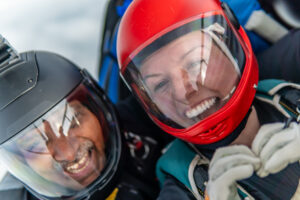 Two skydivers smiling 