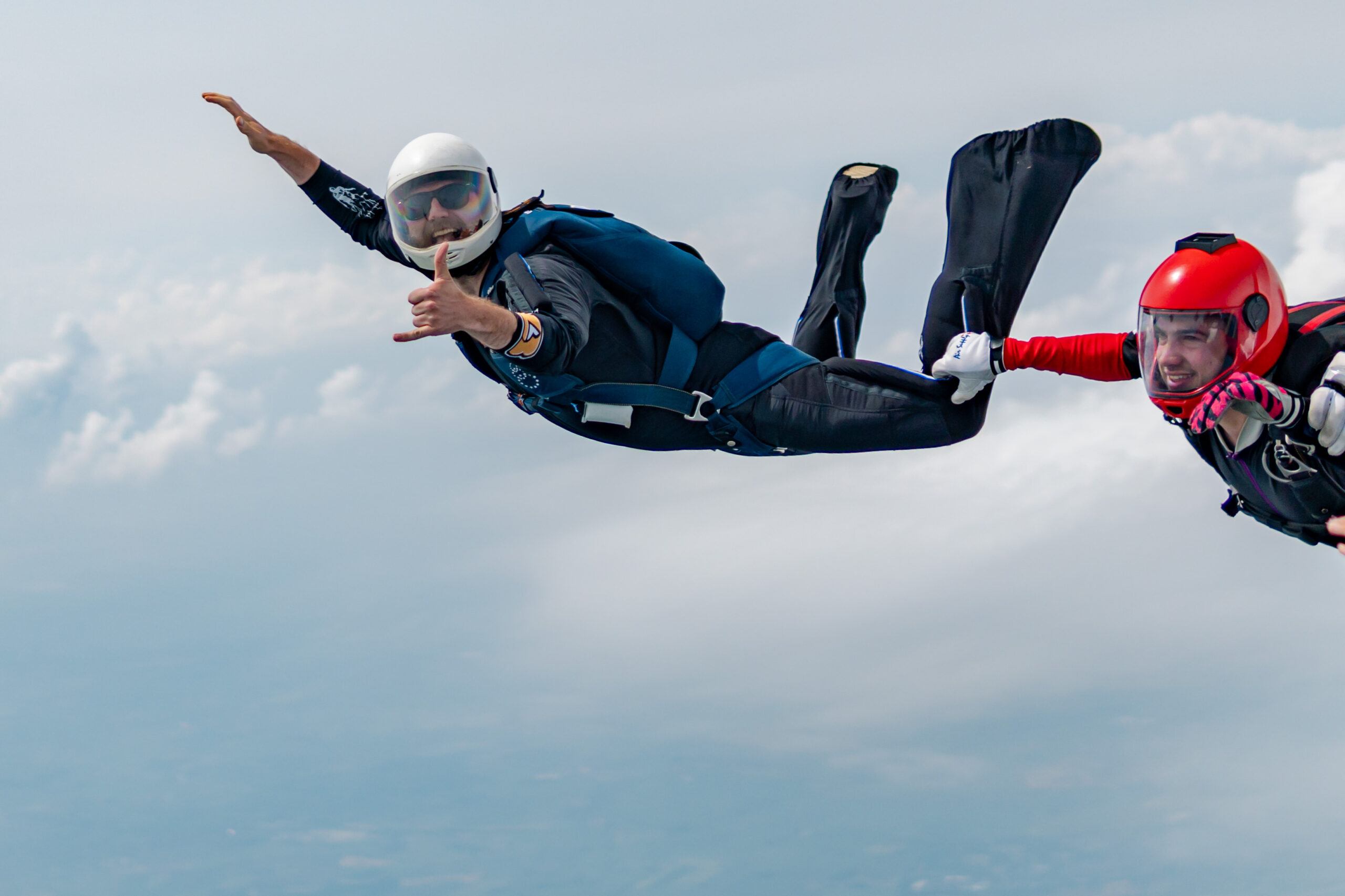 A skydiver posing for a photo mid-jump