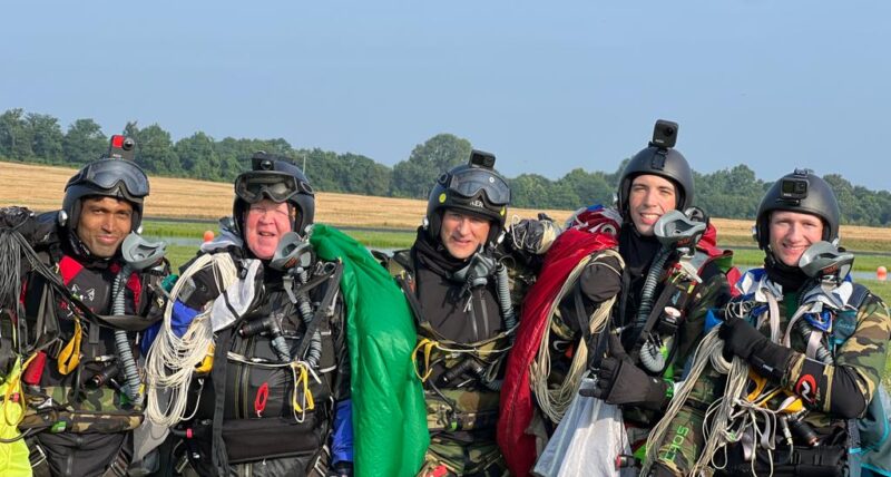 A group of skydivers at a drop zone
